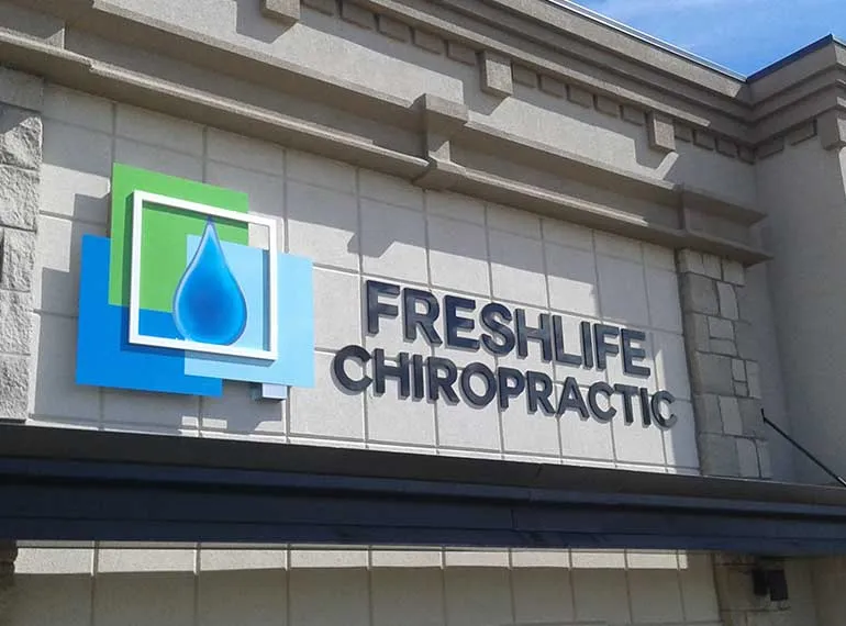 Dimensional storefront sign with raised lettering and logo