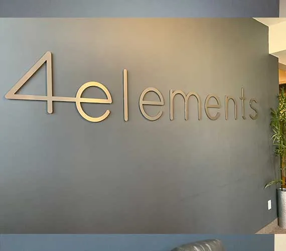 Gold dimensional letters on a grey feature wall