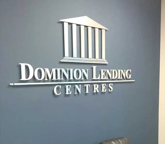 Silver dimensional logo on a blue office wall